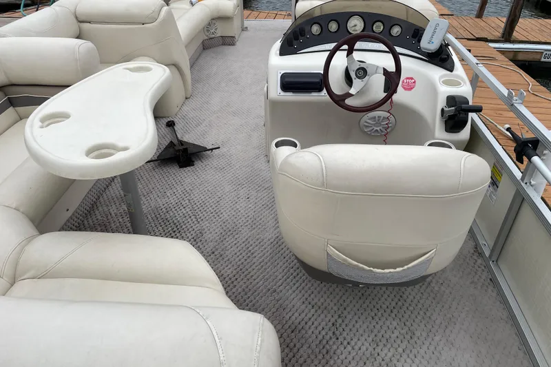Slide: The Image of 2005 Bennington 2275RL boat interior with steering console and seating area. - 6