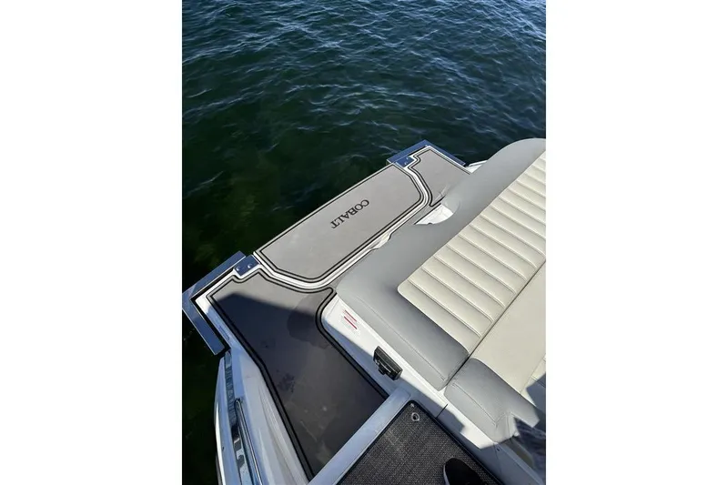 Slide: The Image of 2017 Cobalt 24SD boat with cushioned seating and swim platform on water. - 12