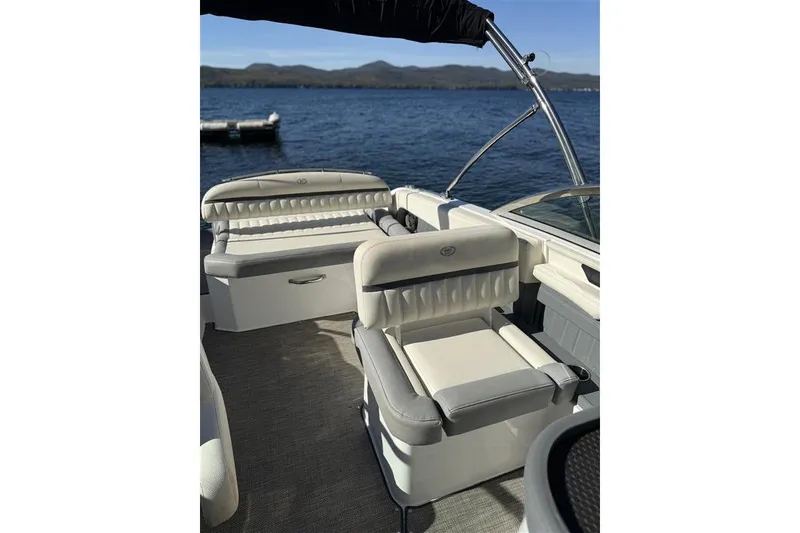 Slide: The Image of 2017 Cobalt 24SD boat interior with plush seating on a sunny day by the water. - 13