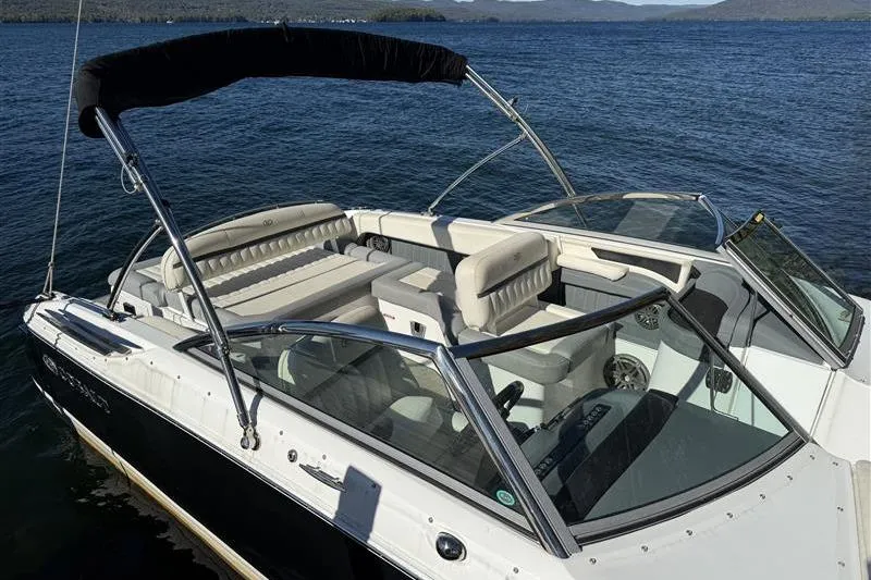 Slide: The Image of 2017 Cobalt 24SD boat with seating, on a calm lake. - 19