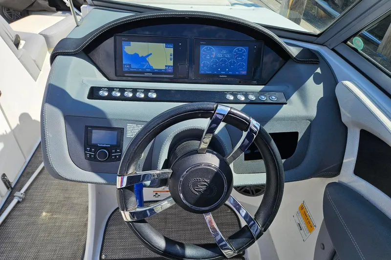 Slide: The Image of Steering console of a 2017 Cobalt 24SD boat with navigation displays. - 21