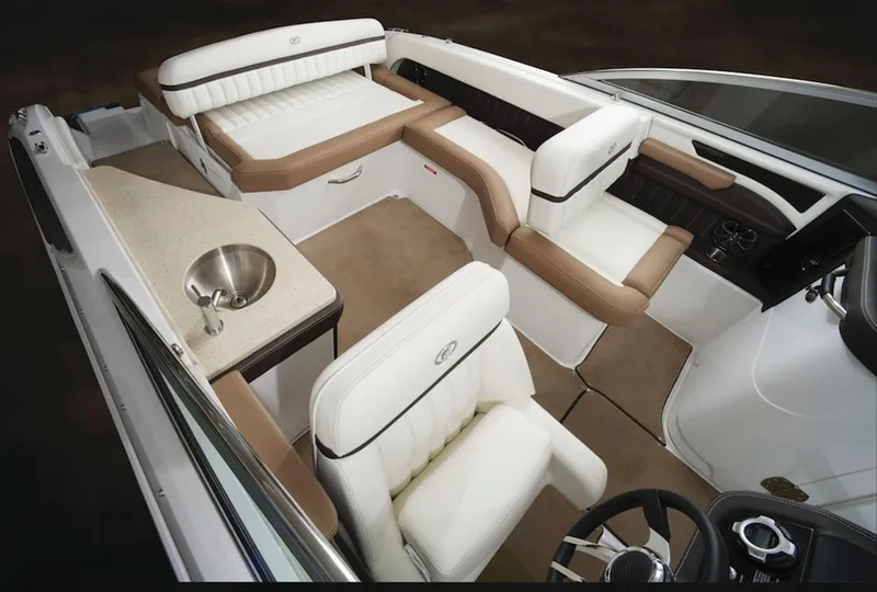 Slide: The Image of Manufacturer Provided Image: 2017 Cobalt 24SD boat interior with white and tan seating, sink, and steering console. - 29