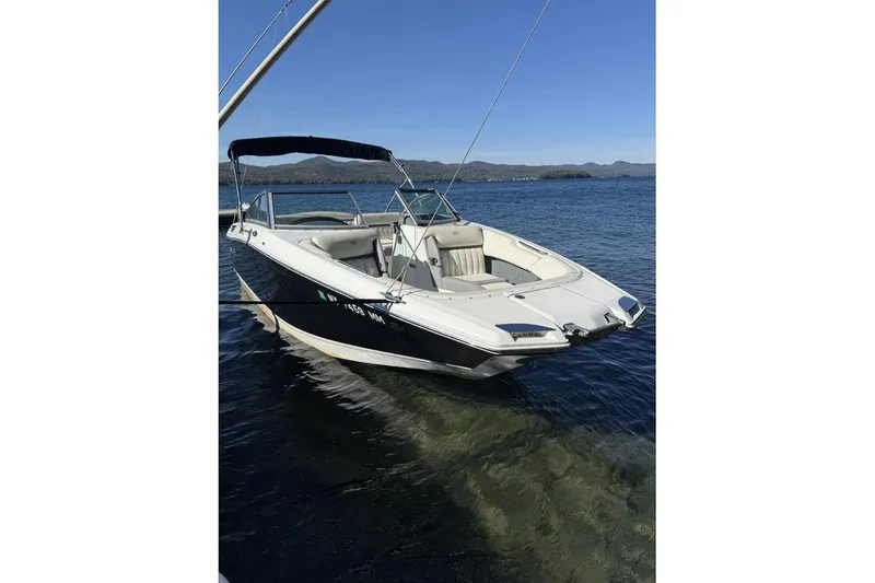 Slide: The Image of 2017 Cobalt 24SD boat on clear water with scenic mountain backdrop. - 3