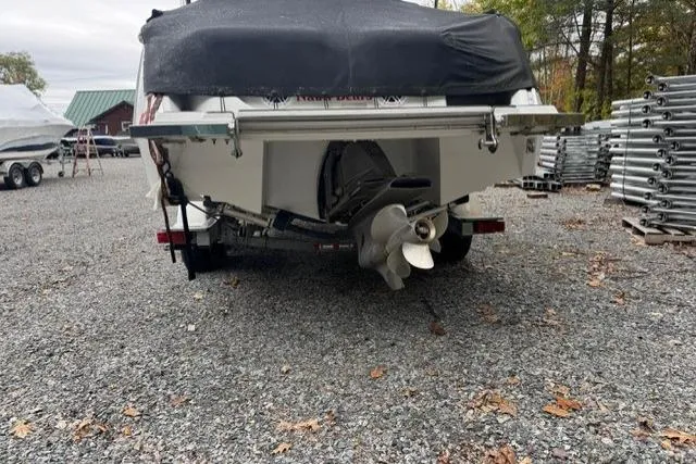 Slide: The Image of Rear view of a 2017 Cobalt 24SD boat on a gravel lot. - 33