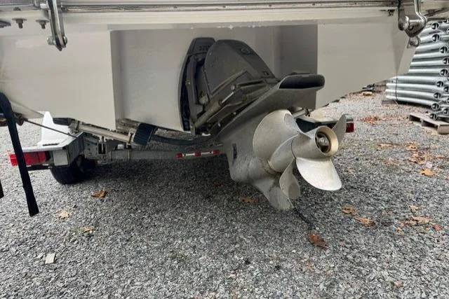 Slide: The Image of 2017 Cobalt 24SD boat stern with propeller on gravel surface. - 34