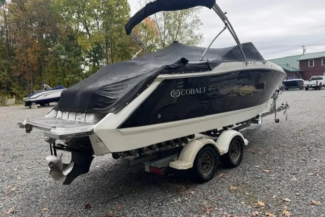 Slide: The Image of 2017 Cobalt 24SD boat on trailer, covered, parked outdoors on gravel. - 35