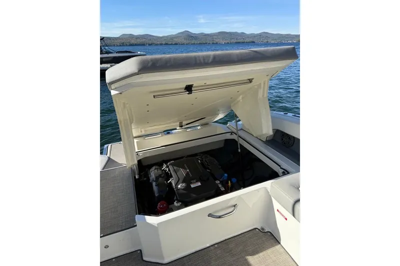 Slide: The Image of 2017 Cobalt 24SD boat engine compartment open on a sunny lake. - 9