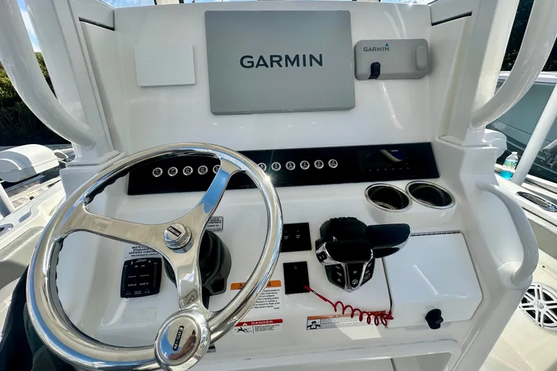 Slide: The Image of 2025 Regulator 23 boat dashboard with Garmin navigation system and steering wheel. - 10