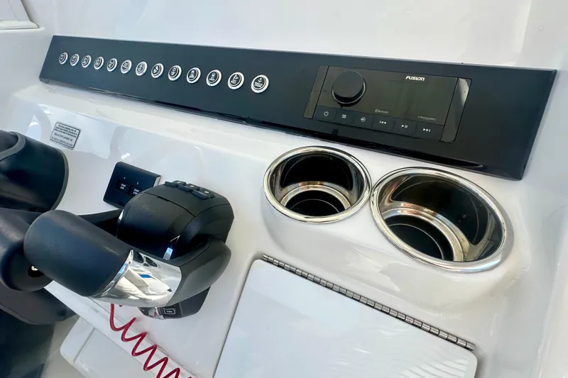 Slide: The Image of Control panel of 2025 Regulator 23 boat with audio system and cup holders. - 12