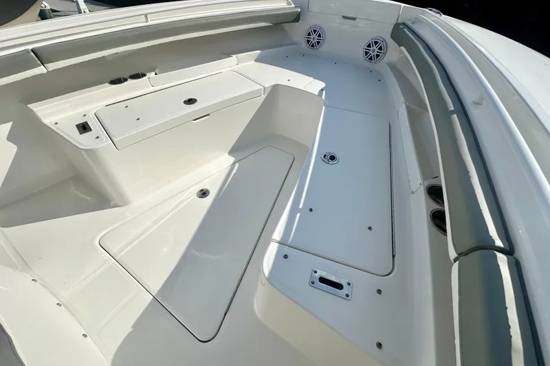 Slide: The Image of 2025 Regulator 23 boat interior with storage compartments and seating. - 14