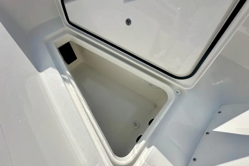 Slide: The Image of Open storage compartment on 2025 Regulator 23 boat, showcasing interior space. - 16
