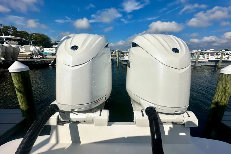 Slide: The Image of Twin outboard motors on a 2025 Regulator 23 boat at a marina. - 6