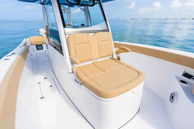 Slide: The Image of 2026 Sportsman Heritage 321 Center Console boat interior with cushioned seating and modern design. - 5