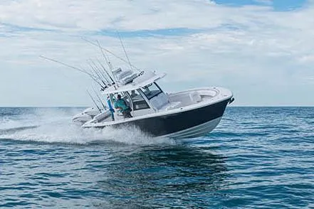 Slide: The Image of 2026 Sportsman Open 322 Center Console boat in a marina, showcasing spacious deck and seating. - 2