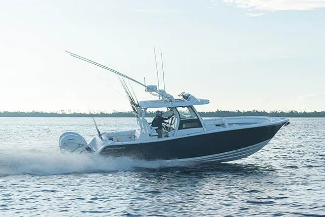 Slide: The Image of 2026 Sportsman Open 322 Center Console boat interior with dual engines and spacious deck. - 3