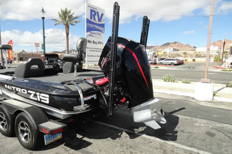 Slide: The Image of 2021 Nitro Z19 Pro boat with powerful outboard motor, parked near RV dealership. - 22