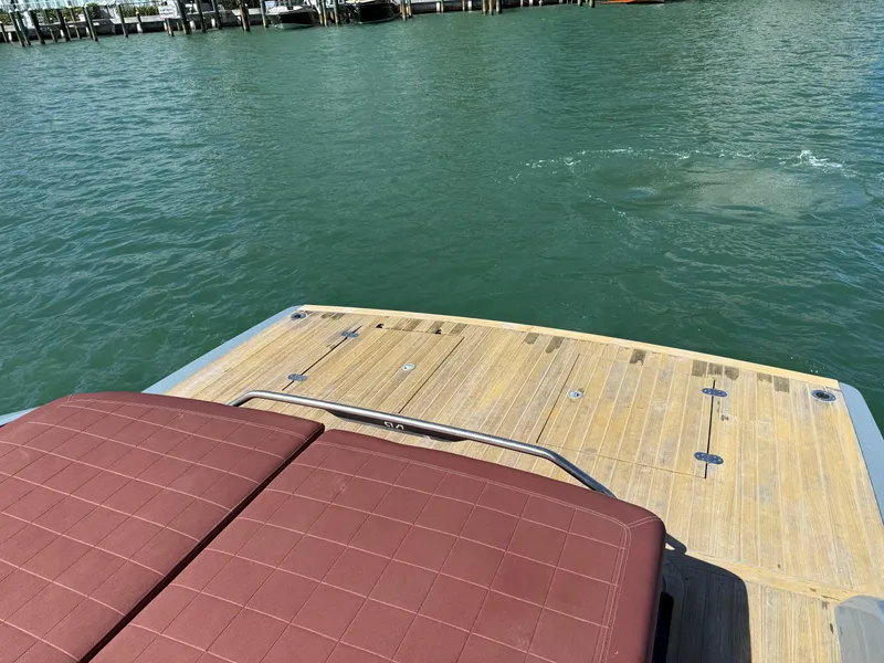 Slide: The Image of 2019 SACS Rebel 40 boat deck with brown seating, overlooking calm water. - 11