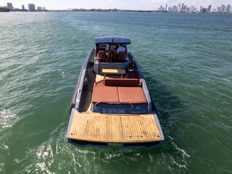 Slide: The Image of 2019 SACS Rebel 40 yacht cruising on open water with city skyline in background. - 3