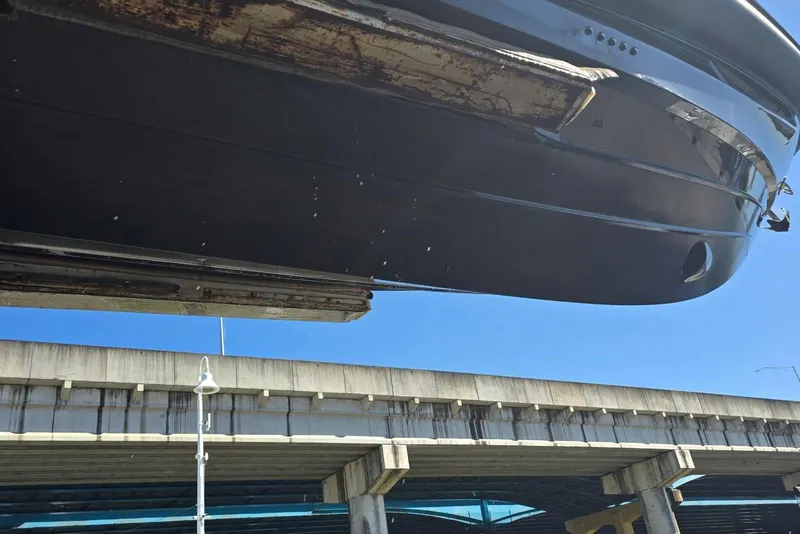 Slide: The Image of 2019 SACS Rebel 40 boat hull under a bridge, clear blue sky. - 45