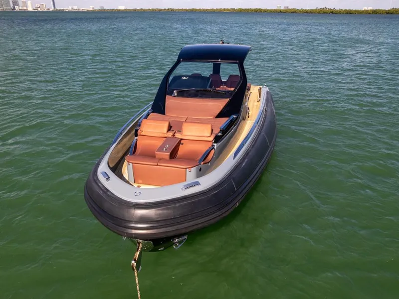 Slide: The Image of 2019 SACS Rebel 40 boat on calm water, featuring sleek design and luxurious seating. - 6