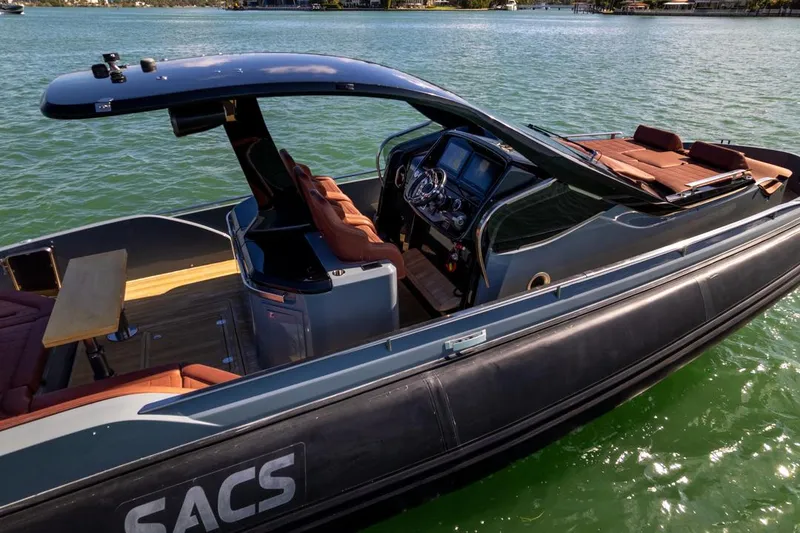 Slide: The Image of 2019 SACS Rebel 40 boat on water, featuring sleek design and luxurious seating. - 7