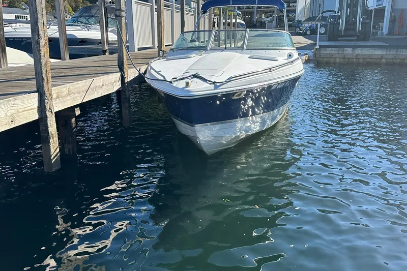Slide: The Image of 2003 Formula 260 Sun Sport boat docked at marina, reflecting on water. - 1