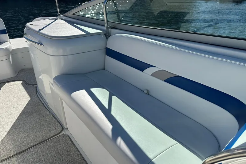 Slide: The Image of 2003 Formula 260 Sun Sport boat interior with blue and white seating, near water. - 12