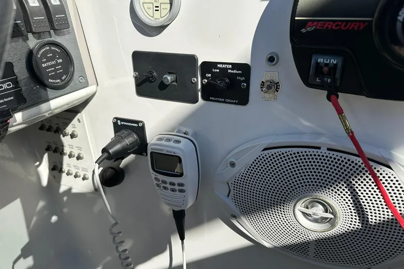 Slide: The Image of Control panel of a 2003 Formula 260 Sun Sport boat with various switches and a speaker. - 14