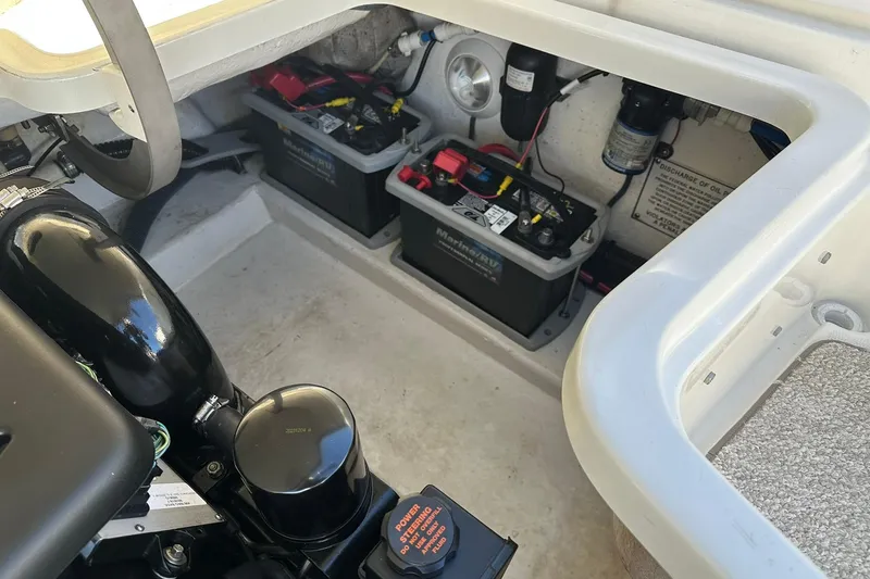 Slide: The Image of 2003 Formula 260 Sun Sport engine compartment with batteries and components visible. - 19