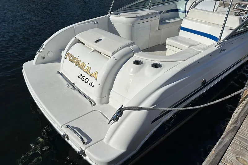 Slide: The Image of 2003 Formula 260 Sun Sport boat docked, showcasing sleek design and spacious seating. - 5