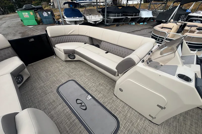Slide: The Image of Interior of a 2021 Harris Sunliner 230 pontoon boat with spacious seating and modern design. - 11