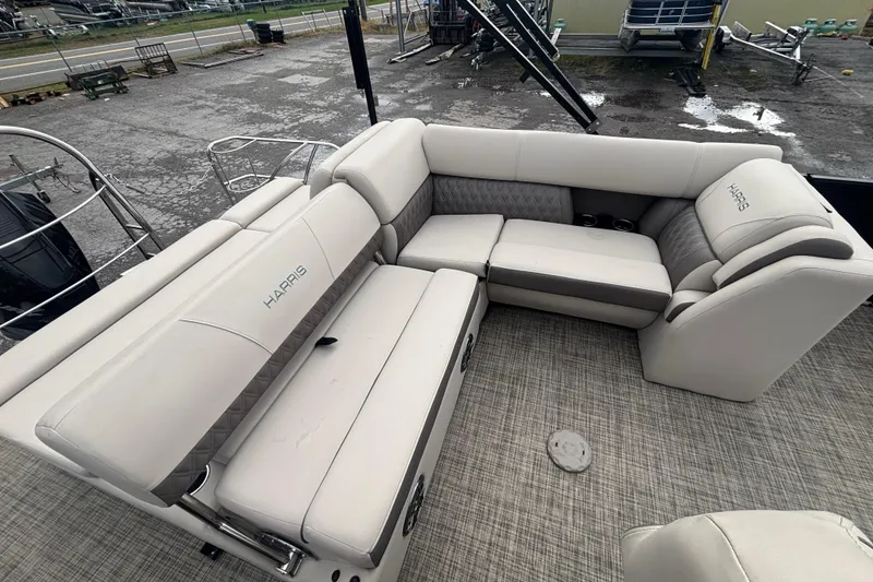 Slide: The Image of 2021 Harris Sunliner 230 boat interior with plush seating and modern design. - 13