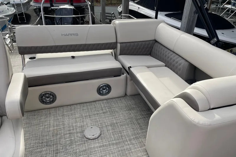 Slide: The Image of 2021 Harris Sunliner 230 boat interior with plush seating and modern design. - 17