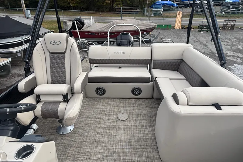 Slide: The Image of 2021 Harris Sunliner 230 pontoon boat interior with plush seating and modern design. - 9