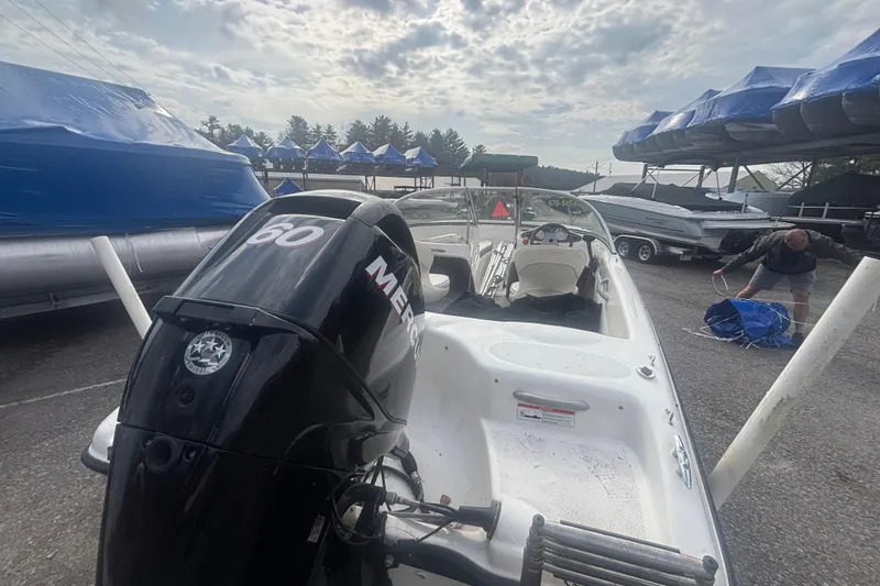 Slide: The Image of 2011 Bayliner 160 Bowrider with Mercury 60 engine in a boatyard setting. - 11
