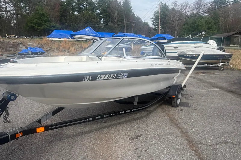 Slide: The Image of 2011 Bayliner 160 Bowrider on trailer in outdoor storage area. - 13