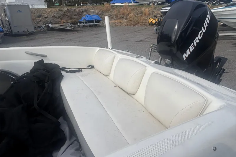 Slide: The Image of 2011 Bayliner 160 Bowrider with Mercury engine, featuring white seating and outdoor setting. - 15