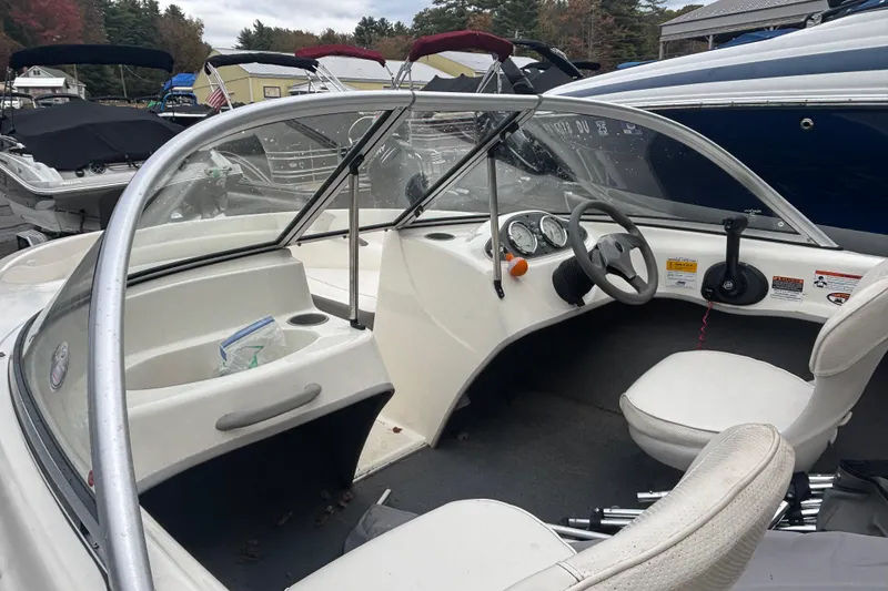 Slide: The Image of 2011 Bayliner 160 Bowrider interior with steering wheel and dashboard controls. - 2