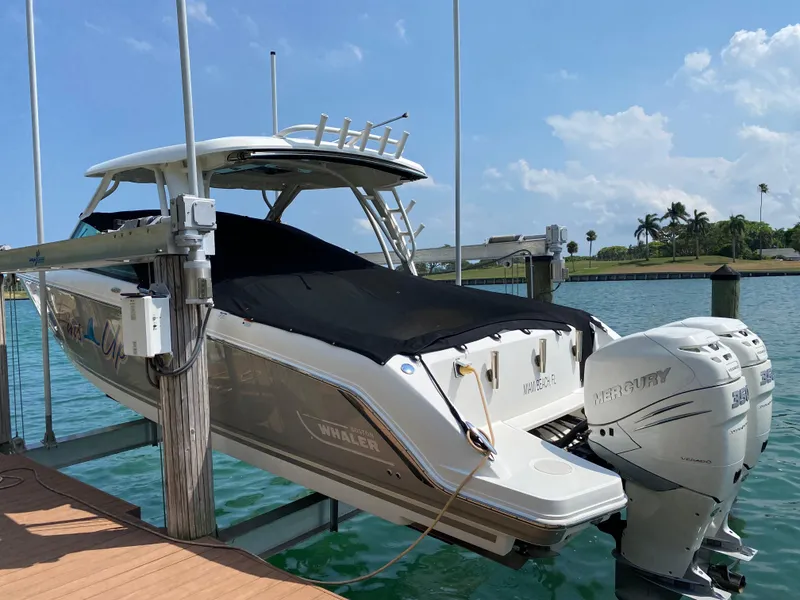 Slide: The Image of 2017 Boston Whaler 320 Vantage boat docked, featuring dual Mercury outboard engines. - 0