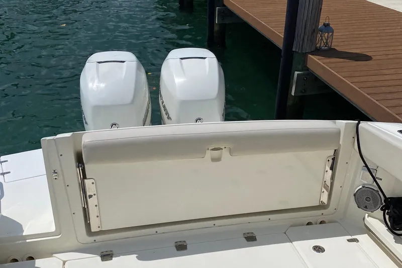 Slide: The Image of 2017 Boston Whaler 320 Vantage boat with twin engines docked by a pier. - 11