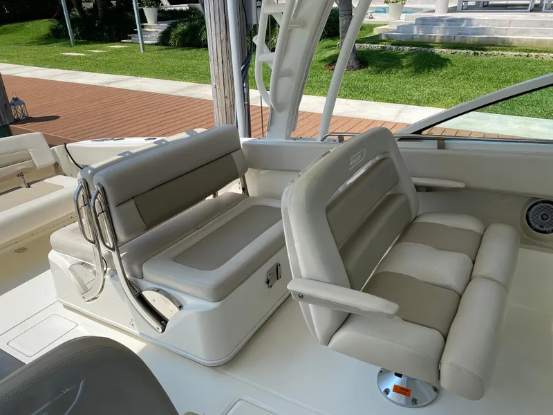 Slide: The Image of 2017 Boston Whaler 320 Vantage boat interior with cushioned seating and sleek design. - 12