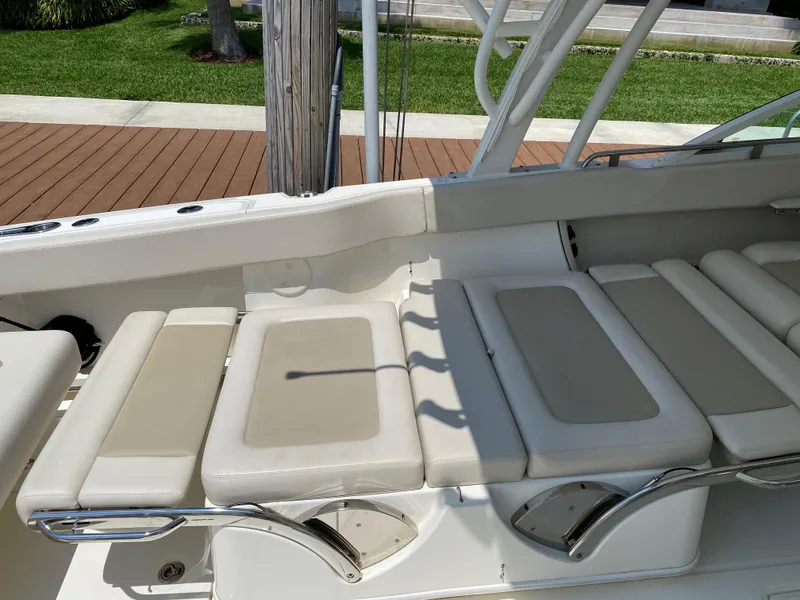 Slide: The Image of 2017 Boston Whaler 320 Vantage boat seating area with beige cushions. - 13