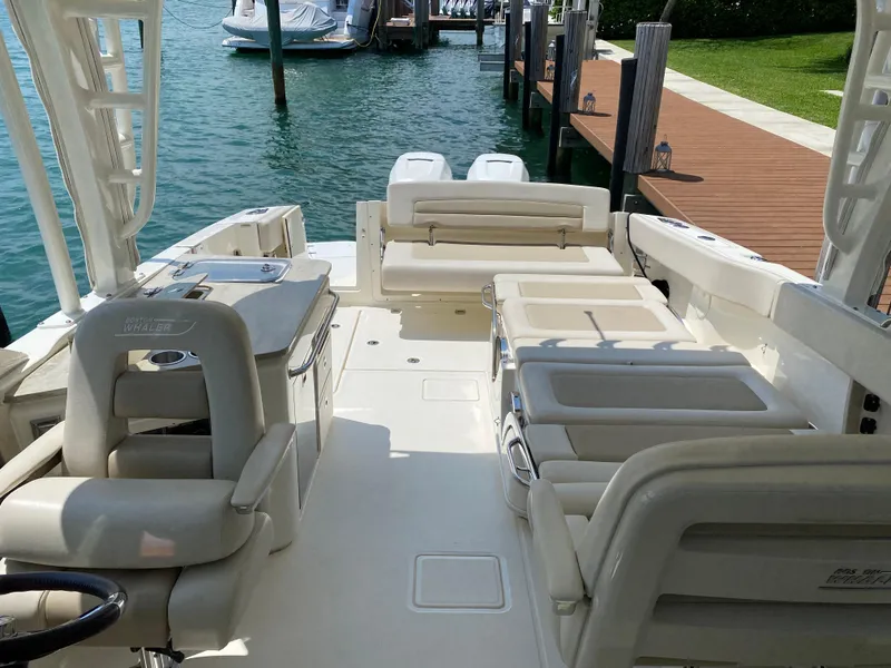 Slide: The Image of 2017 Boston Whaler 320 Vantage boat interior with seating and dock view. - 15