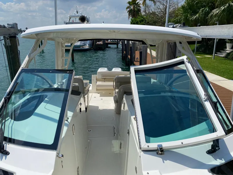 Slide: The Image of 2017 Boston Whaler 320 Vantage boat docked, featuring spacious seating and dual consoles. - 18