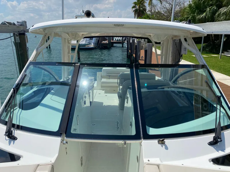 Slide: The Image of 2017 Boston Whaler 320 Vantage boat docked, showcasing spacious interior and sleek design. - 19