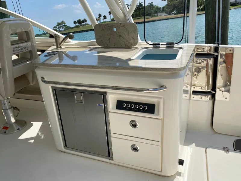 Slide: The Image of 2017 Boston Whaler 320 Vantage boat interior with kitchenette and storage drawers. - 20