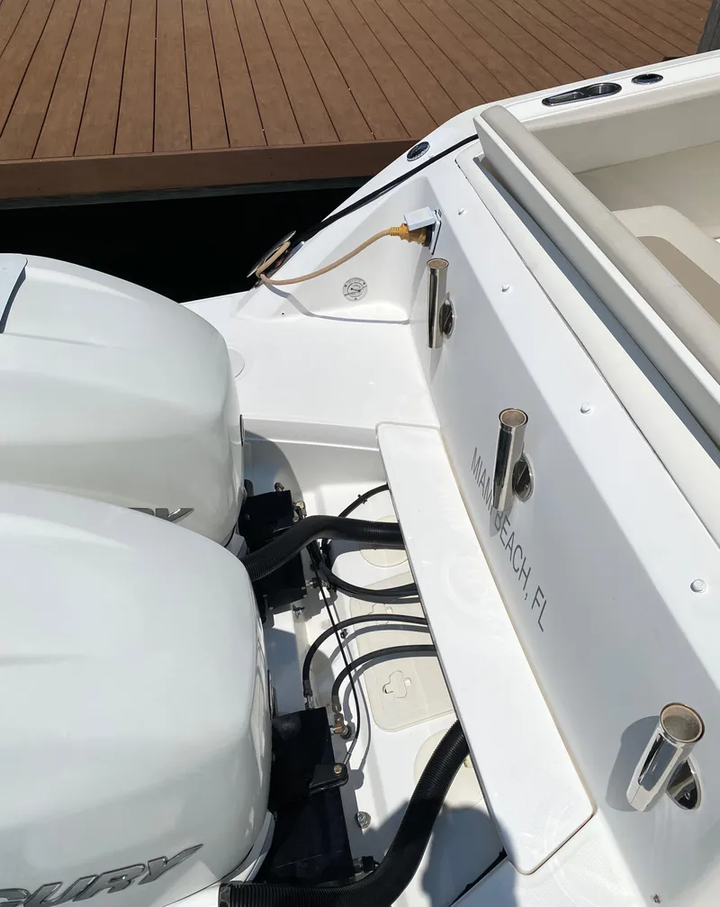 Slide: The Image of 2017 Boston Whaler 320 Vantage boat with dual engines docked at a marina. - 24