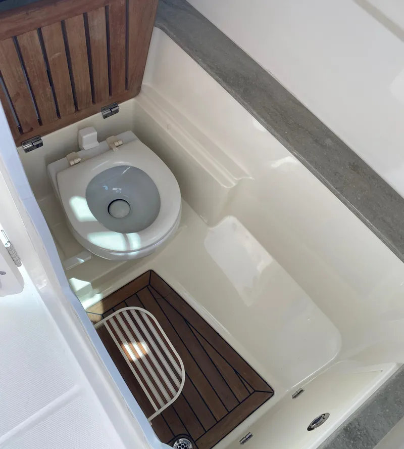 Slide: The Image of 2017 Boston Whaler 320 Vantage boat toilet with wooden flooring. - 26
