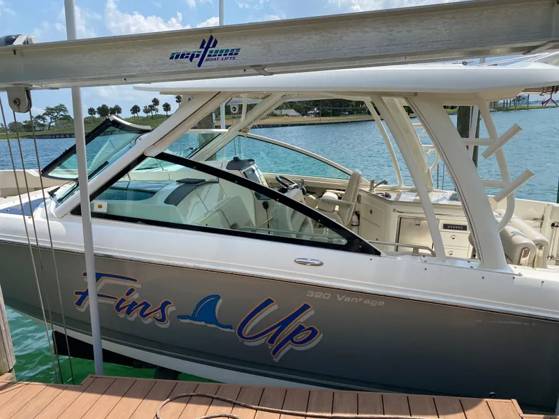 Slide: The Image of 2017 Boston Whaler 320 Vantage boat docked, featuring "Fins Up" graphic. - 3