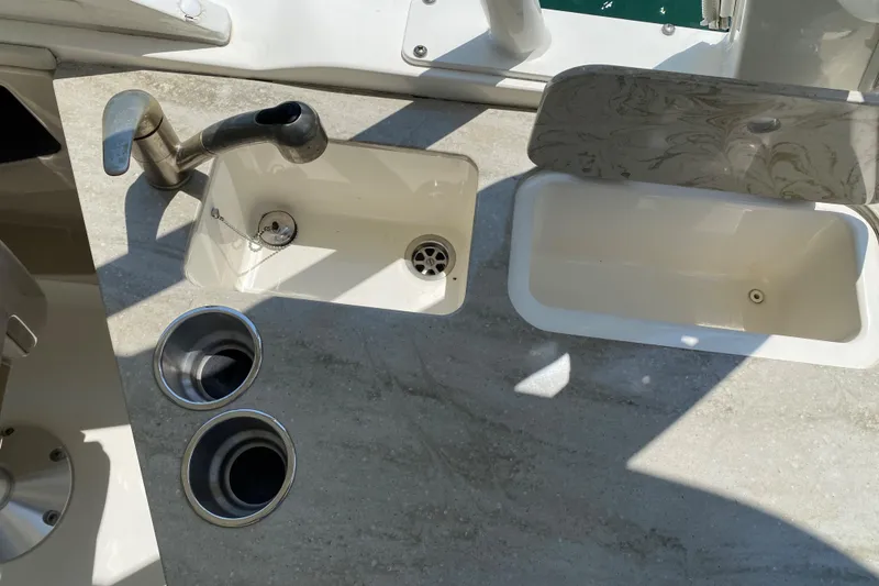 Slide: The Image of Boston Whaler 320 Vantage 2017 boat sink and countertop with cup holders. - 36